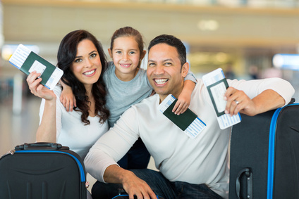 family holding boarding pass and passport